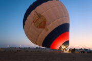 A hot air balloon being inflated before takeoff in the early morning.