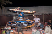 A Tanoura dancer spinning in a desert camp at night.