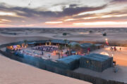 Desert camp with cozy seating and Arabic-style decor at sunset.