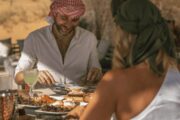 Couple enjoying a private breakfast in a luxurious desert retreat.