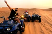 Yamaha Grizzly 350cc quad bike parked on desert sand at sunset.