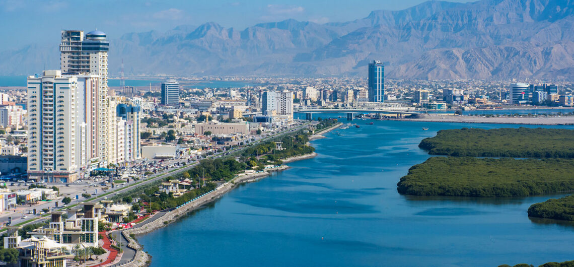 Ras al Khaimah cityscape with waterfront view and mountain range