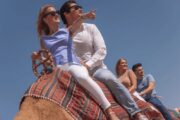 Couple on a camel ride in the Dubai desert