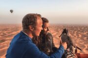 Couple with a falcon in the Dubai desert