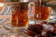 raditional Arabic tea served with dates on an ornate setting.