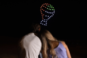 Romantic drone light show with hot air balloon icon