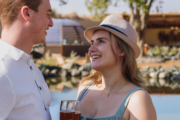 Couple enjoying a romantic lakeside moment at a luxurious desert retreat.