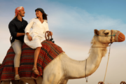 Couple enjoying a camel ride in Dubai desert