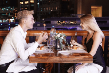 Couple having a romantic candlelight dinner on a luxury Dubai cruise.