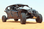 Can-Am Maverick X3 performing a sharp turn in desert dunes.