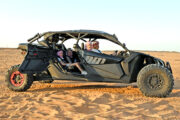 Can-Am Maverick X3 dune buggy parked under a shaded structure.