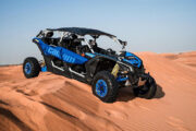 Can-Am Maverick X3 parked on desert dunes, ready for an adventure.