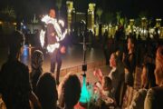 Guests watching fire performance while dining at desert safari camp