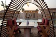 Lakeside dining setup with traditional wooden seating in Dubai desert