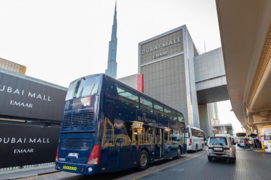 Bustronomy Dubai staff member inside luxury dining bus.