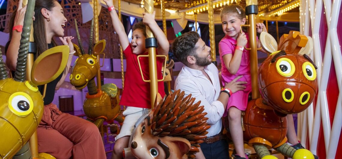 Family enjoying carousel ride at Doha Quest theme park