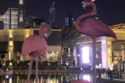 Flamingo sculptures with Burj Khalifa in the background at night