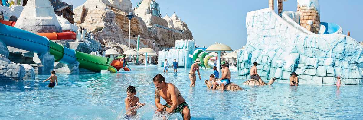 Families enjoying water rides and splash areas at Ice Land Water Park in Ras Al Khaimah