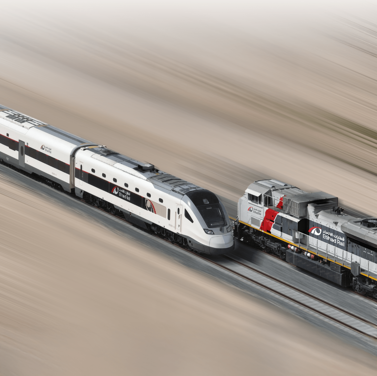 Etihad Rail passenger and freight trains running side by side through the UAE desert.