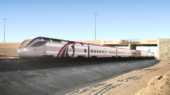 Etihad Rail train traveling through desert terrain in the UAE.
