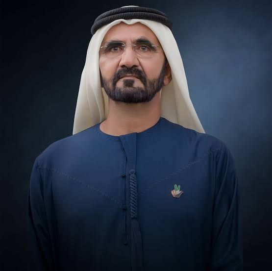 Portrait of a dignified Emirati leader wearing a traditional kandura and ghutra with a dark background.