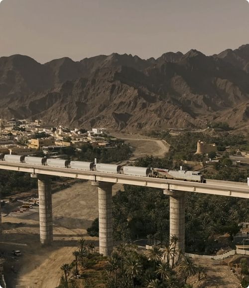 Etihad Rail passenger and freight trains at rail yard in UAE.