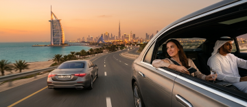 luxury chauffeur service Dubai Burj Al Arab skyline sunset private car experience UAE