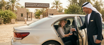 chauffeur serving water to traveler at Hili Archaeological Park Al Ain UAE