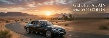tourists exploring desert heritage village with chauffeur and luxury SUV UAE