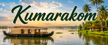 Sunset view of a luxury houseboat on the Kumarakom backwaters surrounded by palm trees.