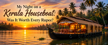 Traditional Kerala houseboat illuminated during sunset on the peaceful backwaters