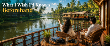 Couple planning their Kerala houseboat journey while enjoying scenic backwater views from the deck.
