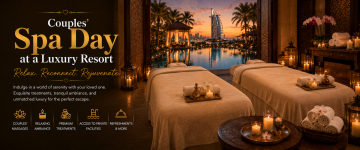 Elegant spa treatment room with massage beds, candles, orchids, and a luxury resort overlooking the Burj Al Arab.
