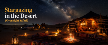 Luxury desert camp under the Milky Way with traditional Arabian tents, lanterns, camels, and a campfire.