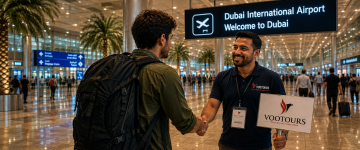 VooTours representative welcoming a traveler at Dubai International Airport